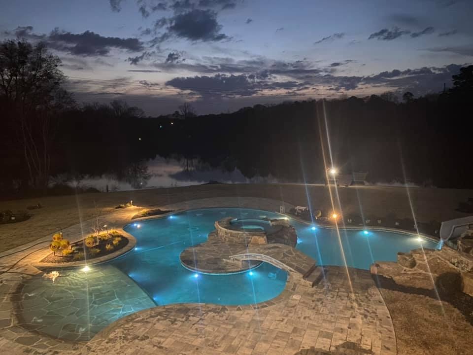 Beautiful swimming pool in Monroe, Georgia, with a custom slide, grotto, and island.